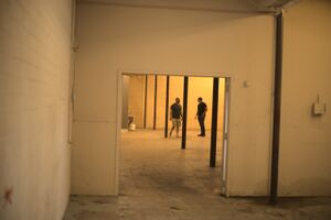 East of loading bay, joining warehouse.